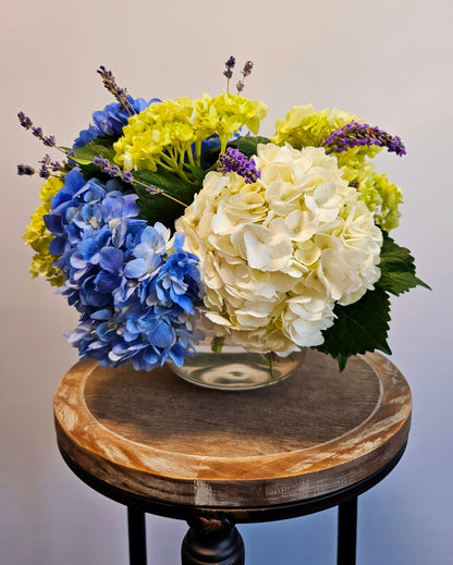 Blue, white and green hydrangea accented with lavender blossoms