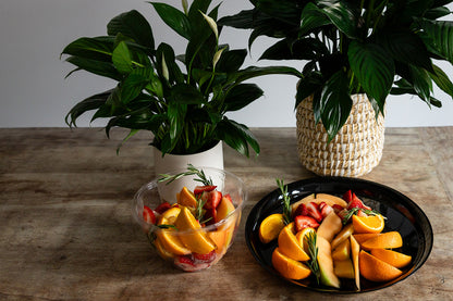 Fruit platter with fresh seasonal fruits and peace lilies