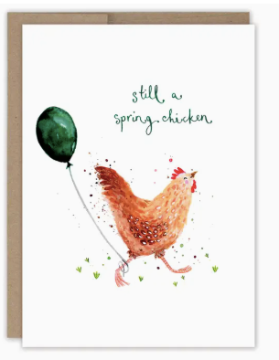 Greeting card with a chicken holding a green balloon and text 'still a spring chicken' on a white background birthday greeting card